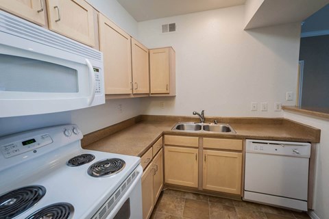 Kitchen with brown cabinets at Villa Springs, Houston, Texas